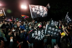 Hong Kong anti-government protesters attend a rally in support of Taiwan President Tsai Ing-wen outside the Democratic Progressive Party headquarters in Taipei, Taiwan Jan. 11, 2020.