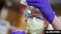 A dose of the coronavirus disease vaccine is prepared at UW Health in Madison, Wisconsin, Dec. 14, 2020. 