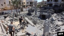 Palestinians gather amid the rubble near a fuel tank damaged in Israeli bombing in Gaza City on Sept. 14, 2024.