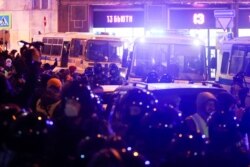Law enforcement officers stand guard during a demonstration after Russian opposition leader Alexei Navalny was sentenced to three and a half years in jail, in Moscow, Feb. 2, 2021.