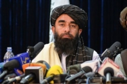 Taliban spokesperson Zabihullah Mujahid looks on as he addresses the first press conference in Kabul on Aug. 17, 2021 following the Taliban stunning takeover of Afghanistan.