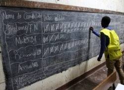 FILE - Vote counting takes place after the polling station closed in Maputo, Mozambique, Oct. 15, 2019.