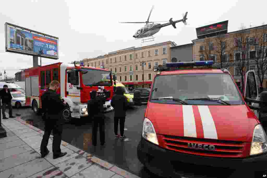 A helicopter flies over the fire trucks after an explosion at Tekhnologichesky Institut subway station in St.Petersburg, Russia, April 3, 2017. 