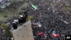 Syrians continue to celebrate the ousting of Bashar al-Assad's government, at Umayyad Square, in Damascus, Syria, Dec. 20, 2024. 