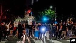 Demonstrators block traffic during a protest Wednesday, May 27, 2020, in Los Angeles over the death of George Floyd in Minneapolis police custody earlier in the week. 