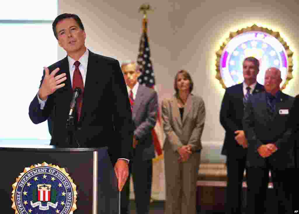 FBI Director James Comey answers a question during a news conference at the FBI field office in Denver, Aug. 20, 2014.
