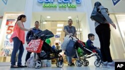 FILE - Shoppers walk through a mall in Miami, Florida, Feb. 12, 2016.