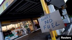 A sign showing customers that fuel has run out is pictured at the Hilltop Garage petrol station, in Rothley, Leicestershire, Britain, Sept. 25, 2021.