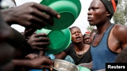 Internally displaced people wait for food distribution at an internally displaced persons (IDP) camp in Bunia, Ituri province, eastern Democratic Republic of Congo, April 12, 2018. 