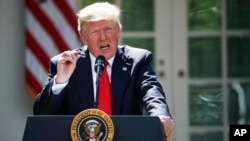 President Donald Trump speaks about the U.S. role in the Paris climate change accord, June 1, 2017, in the Rose Garden of the White House in Washington. 