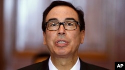 FILE - U.S. Treasury Secretary Steve Mnuchin leads a meeting of the Financial Stability Oversight Council at the Treasury Department in Washington, Oct. 16, 2018.