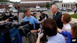 Senator Luther Strange talks with media after voting with his wife, Melissa, Aug. 15, 2017, in Homewood, Ala. 