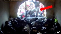 This image from video from the U.S. Justice Department contained in the sentencing memorandum, and annotated by the source, shows David Nicholas Dempsey stomping on police officers in the Lower West Terrace Tunnel at the U.S. Capitol on Jan. 6, 2021, in Washington.