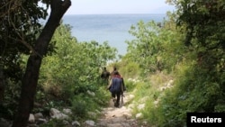 FILE - Islamist fighters are seen in Latakia province, Syria, not far from the Turkish border, March 31, 2014.