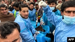 Paramedics transport an injured police officer at a hospital following a roadside bomb blast in Bajaur district, around 14 kms from the border with Afghanistan, on Jan. 8, 2024.