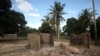 FILE - Burned-out huts are seen at the scene of an armed attack in Chitolo village, Mozambique, July 10, 2018. 