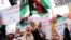 FILE - Libyan women chant slogans during a demonstration to demand an end to the Khalifa Haftar's offensive against Tripoli, in Martyrs' Square in central Tripoli, Libya, April 26, 2019.