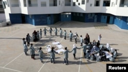 FILE - Palestinian children take part in an activity at a school run by United Nations Relief and Works Agency in the Shuafat refugee camp in East Jerusalem October 10, 2018.