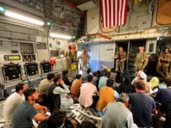FILE - U.S. Marine Corps Gen. Frank McKenzie, the commander of U.S. Central Command, enters a plane evacuating people, at Hamid Karzai International Airport, Afghanistan, Aug. 17, 2021.