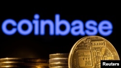 FILE: A representation of the cryptocurrency is seen in front of Coinbase logo in this illustration taken, March 4, 2022.