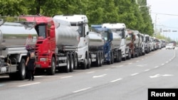 A member of the Cargo Truckers Solidarity union stands next to a truck during a strike in Yeosu, South Korea, June 9, 2022.