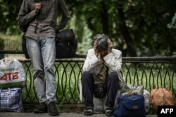 Residents wait as they evacuate from the city of Sloviansk in the eastern Ukrainian region of Donbas, June 2, 2022.
