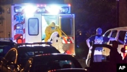FILE - An ambulance carrying Amber Joy Vinson, the second health care worker to be diagnosed with Ebola in Texas, arrives at Emory University Hospital, in Atlanta, Oct. 15, 2014.