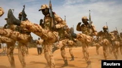 FILE - Chadian soldiers march during Flintlock 2014, a U.S.-led international training mission for African militaries, in Diffa, Niger, March 3, 2014. 