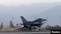 FILE - A U.S. Air Force F-16 Fighting Falcon aircraft takes off for a nighttime mission at Bagram Airfield, Afghanistan, Aug. 22, 2017. 