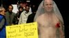 FILE - An activist dressed as a condom protests in Hong Kong, Dec. 1, 2004, the lack of adequate sex education in Hong Kong schools and said the level of HIV infections will rise dramatically because many in Hong Kong are having unprotected sex.