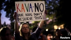 Activists gather outside the U.S. Supreme Court to hold a vigil in opposition to U.S. Supreme Court nominee Brett Kavanaugh in Washington, Oct. 3, 2016.
