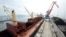 FILE - A cargo ship is loaded with coal at the North Korean port of Rajin, July 18, 2014. 