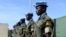 FILE - Ugandan peacekeeping troops stand during a ceremony at Mogadishu airport in Somalia.