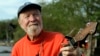 FILE - Folk singer Pete Seeger plays his banjo in Beacon, New York, May 5, 2006.