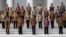 Indonesian President Joko Widodo, front row, center, and his deputy Jusuf Kalla, front row, second right, pose with the newly appointed cabinet ministers after their the inauguration ceremony at the presidential palace in Jakarta, Indonesia, Oct. 27, 2014