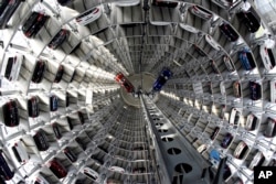 Volkswagen cars are lifted inside a delivery tower of the company in Wolfsburg, Germany, March 14, 2017.