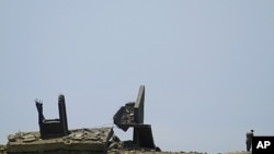 Special policemen and investigators work next to a damaged guard post that was result of an explosion's concussion wave at the Evangelos Florakis naval base in Mari, Cyprus, July 12, 2011