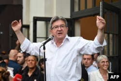 FILE - Leader of left-wing coalition Nupes Jean-Luc Melenchon delivers a speech after the first results of the second round of the parliamentary elections in Paris, June 19, 2022.