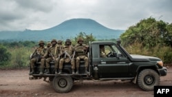 FILE: Members of the Congolese army head for the front lines near the North Kivu city of Goma during clashes between the Congolese army and M23 rebels.
