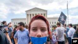 An abortion-rights protester wearing tape that reads "2nd Class Citizen" demonstrates following Supreme Court's decision to overturn Roe v. Wade outside the Supreme Court in Washington.