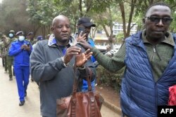 A member of the Maa unity agenda (L) is arrested during the protest in Nairobi, condemning the forceful eviction of the Loliondo Ngorongoro Maa community by the republic of Tanzania, on June 17, 2022.