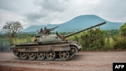 FILE - A Congolese army tank heads towards the front line near Kibumba in the area surrounding the North Kivu city of Goma during clashes between the Congolese army and M23 rebels, May 25, 2022.