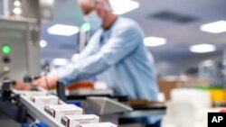 FILE - This May 2022 photo provided by Pfizer shows production of the Pfizer's COVID-19 vaccine for children under 5 in Puurs, Belgium. 