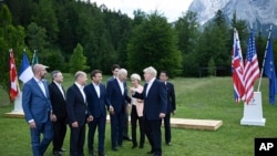 Britain's Prime Minister Boris Johnson, second right, speaks with from left, European Council President Charles Michel, Italy's Prime Minister Mario Draghi, Germany's Chancellor Olaf Scholz, France's President Emmanuel Macron, US President Joe Biden, Eur