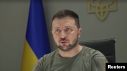 Ukrainian President Volodymyr Zelenskyy is seen addressing African Union representatives via videolink in this screen grab from Reuters video.