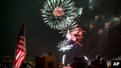FILE - Spectators watch as fireworks explode overhead during the Fourth of July celebration in Prescott, Ariz. The skies over a scattering of Western cities will stay dark for the third consecutive Fourth of July in 2022 as some big fireworks displays are canceled again.