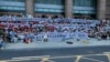People hold banners and chant slogans during a protest at the entrance to a branch of China's central bank in Zhengzhou in central China's Henan Province, July 10, 2022. (AP via Yang) 