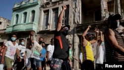 FILE - Protesters shout slogans against the government during a demonstration, which also involved counter-protesters who are in support of the government, in Havana, Cuba July 11, 2021. 