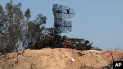 Damaged radars are seen in Tripoli as part of a guided tour for journalists, March 25, 2011