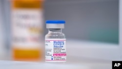 A vial of the Moderna COVID-19 vaccination for children under 5 sits on a counter at Walgreens pharmacy Monday, June 20, 2022, in Lexington, S.C.